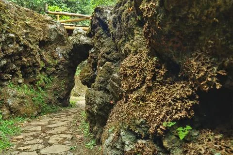 Stone paths passing through natural rocks and cliff. Stock Photos
