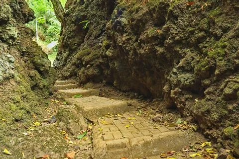 Stone paths passing through natural rocks and cliff. Stock Photos