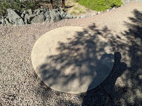 Stone pathway featuring a large compass-shaped concrete symbol Stock Photos