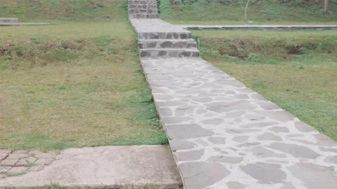 Stone pathway leading up steps through a grassy park area. Video stock 343386435