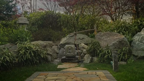 Stone Pathway To Mossy Statue Leading Through Rock Garden 動画素材 335950487