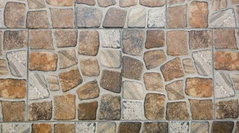 Stone pattern tiles. Ceramic finish. Brown-gray background. Finishing materia Stock Photos