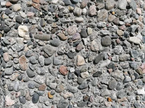 Stone pattern wall with lots of pebbles in different colors Stock Photos