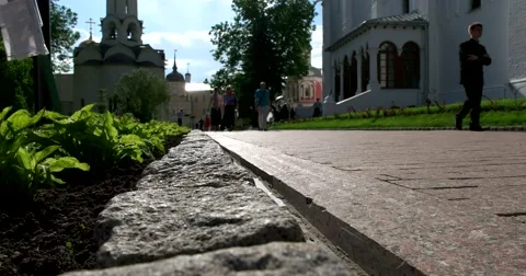 The stone-paved alleys in the monastery complex, the parishioners Stock Footage 67696808