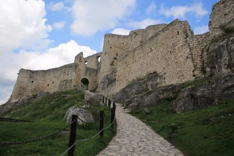 Stone paved path leading to an ancient fortress on a hill. Stock Photos