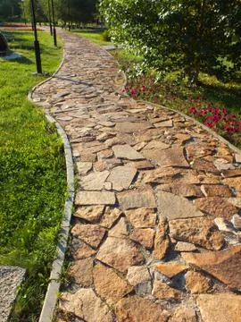 A stone-paved path in the park Stock Photos