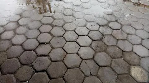 Stone pavement with hexagonal tiles on ground outdoors Stock Photos