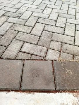 Stone pavement with rectangular and square tiles outdoors Stock Photos