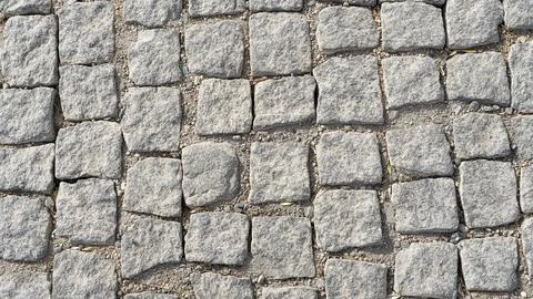 Stone pavement texture. Abstract background of cobblestone pavement Stock Photos