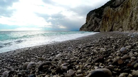 Stone pebbles and sun breaks through clouds Stock Footage 72075708