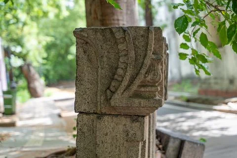 A stone pillar with a leaf design on it. in Chennai Stock-Fotos