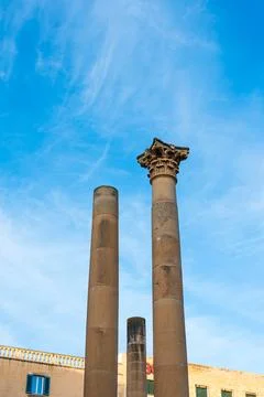 Stone pillars standing tall in malta, valletta with sunny clear blue skies Stock Photos