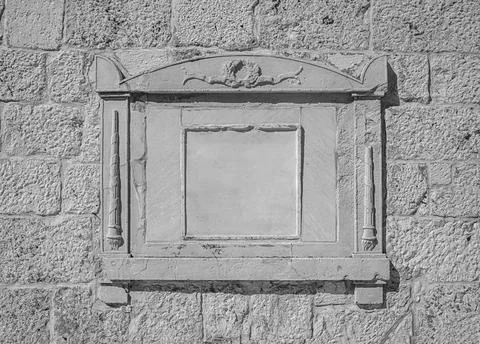 A stone plaque, framed by decorative elements Stock Photos
