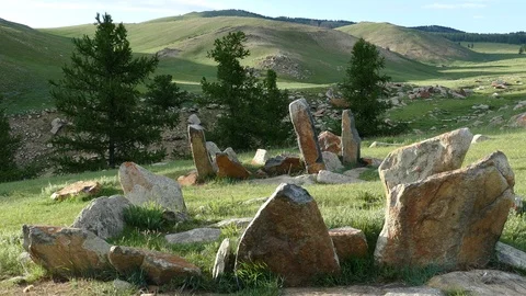 Stone plates of ancient burial structures  Kheregsuurs  in the Mongolian steppe. Stock Footage 90841058