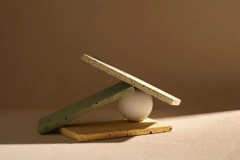 Stone podiums in rectangle shape with many color are stacked with a white bal Stock Photos