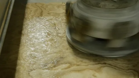 Stone polisher machine working on piece of stone. Machine smoothing and Stock Footage 295551686
