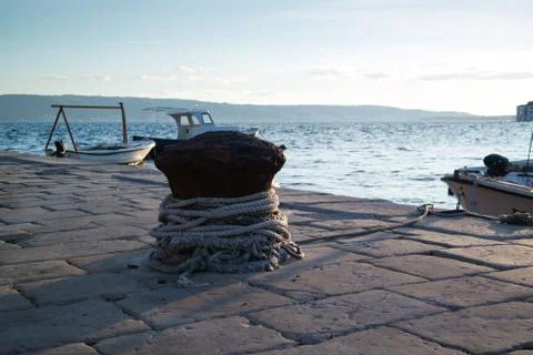Stone port and scenic blue sea. Fisherman rope. Stock Photos