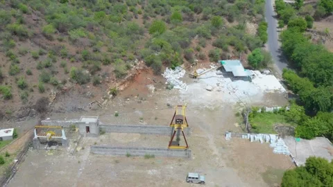 Stone Processing Yard with Gantry Crane in Hilly Terrain Stock Footage 312365311