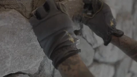 Stone pushed in place with spacer on wall 動画素材 339284204