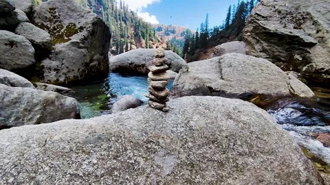 Stone pyramid clean water splash stream in the rocks at mountain waterfall view Stock Footage 305409722