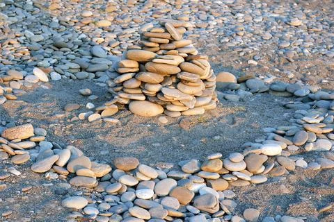 Stone pyramid on the sand beach Stock Photos