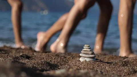 Stone pyramid on sandy beach by Mediterranean sea Stock Footage 161780195