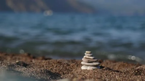 Stone pyramid on sandy beach by Mediterranean sea Stock Footage 162493656