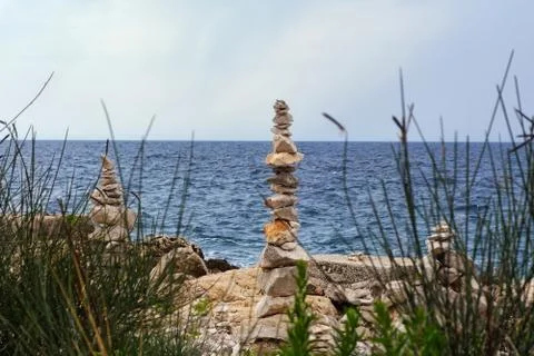 Stone pyramids on the shore. Stock Photos