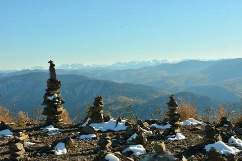 Stone ritual pyramids on the top of a mountain covered with the first snow .. Stock Photos