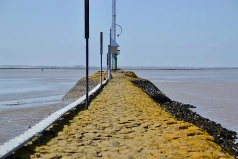 Stone road to the lighthouse Stock Photos