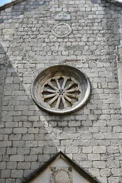 Stone Rose Window on Old Mediterranean Church Facade Stock Photos