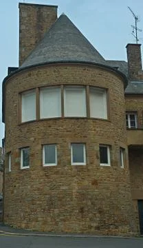 Stone rounded house tower with windows Stock Photos