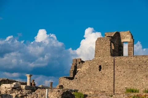 Stone ruins of Pompeii with dramatic clouds Photos