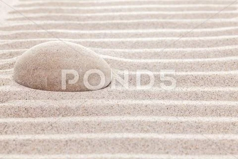 Stone in sand, spa or spiritual background Stock Photos