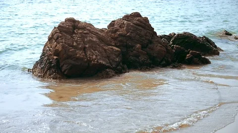 Stone on sandy beach washed by sea waves Stock Footage 101873989