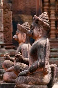 Stone sculputure sitting in front of temple B Stock Photos