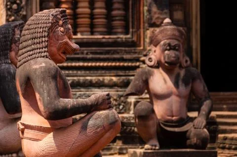 Stone sculputure sitting in front of temple B Stock Photos