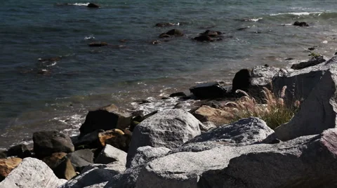 Stone shore or coast with waves of the Pacific ocean on Malibu, California Stock Footage 54978060