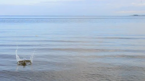 Stone skipping on water Stock Footage 54463762