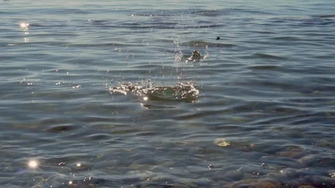 Stone Skipping On Water Surface. Reflection Of Sunset In Water. Slow motion. Stock-Footage 119540593