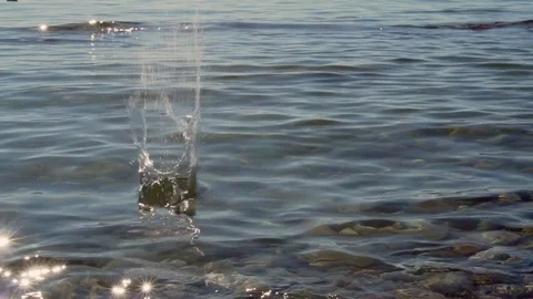 Stone Skipping On Water Surface. Reflection Of Sunset In Water. Slow motion. Stock Footage 119540717