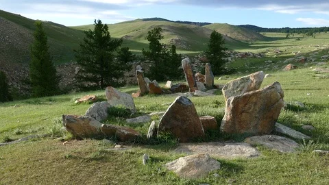 Stone slabs of ancient burial structures  Kheregsuurs  in the Mongolian steppe. Stock Footage 90841046