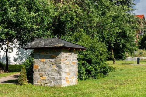 Stone small structure in a green park on a sunny day Stock Photos