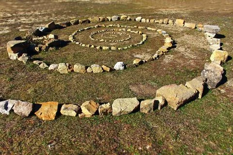 Stone Spiral Pattern on Grassy Ground Stock-Fotos