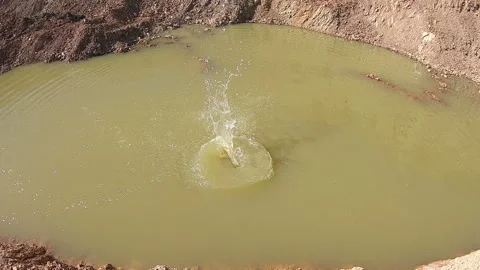 Stone splashing in water puddle Stock Footage 159997564