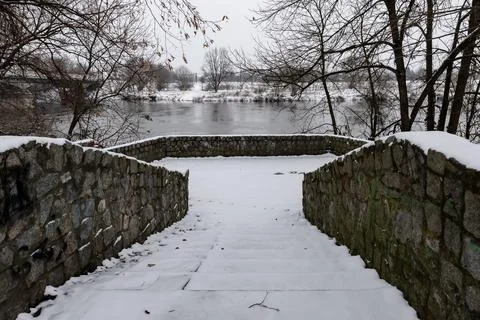Stone square by Odra river on cloudy winter day Фото