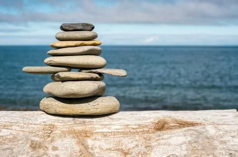 Stone stack on beach with faded retro filter Stock Photos