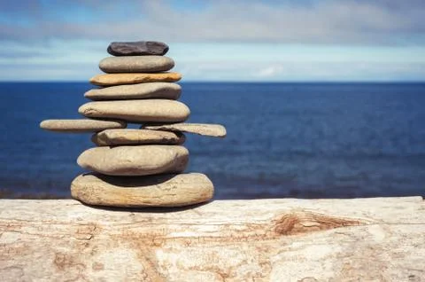 Stone stack on beach with faded retro filter Stock Photos