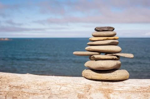 Stone stack on beach with faded retro filter Stock Photos