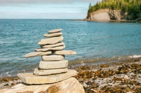 Stone stack on beach with faded retro filter Stock Photos